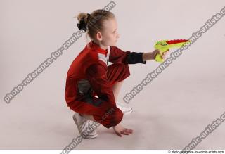 DENISA SITTING POSE WITH GUN